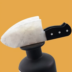 Close-up of a novelty acrylic chef knife hair claw clip with marble texture detail