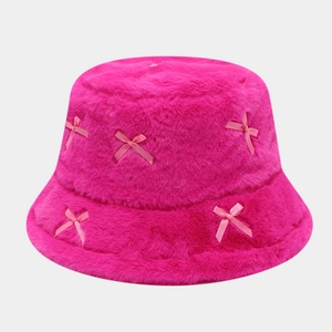 Close-up of bright pink faux fur bucket hat with delicate light pink silk bow details