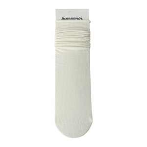 Japanese style cream white slouch socks made of soft knit fabric on paper card