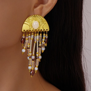 Golden semi-circular tassel earrings with beads on model for elegant vintage styling