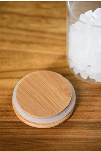 Detail of wooden lid with silicone sealing ring on clear glass storage jar