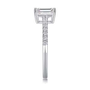 Detail of emerald cut moissanite ring in S925 silver with sparkling pavé side stones