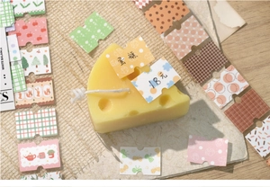 Macro detail of floral scrapbook stickers and vintage labels on textured background