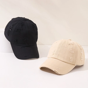 Detail of distressed vintage cotton baseball caps in black and beige for kids