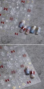 Detailed view of Christmas bow and snowflake nail art stickers with textured finish