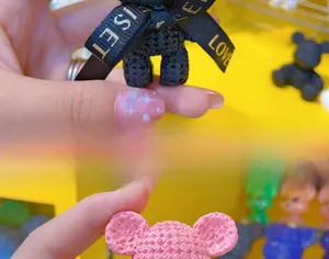 Close-up of bear keychain with unique woven texture and LOVE ribbon detail