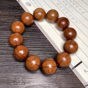 Macro detail of natural Wutai Mountain wood beads showing deep wavy wood grain texture