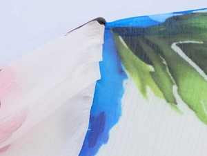 Detailed close-up showing the floral print texture and lightweight chiffon fabric of the top