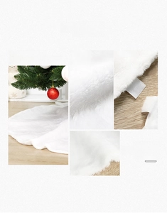 Detail of white plush Christmas tree skirt showing faux fur texture and velcro fastener