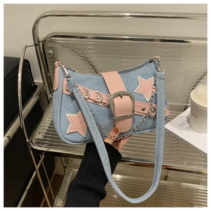 Detail of Y2K denim underarm bag featuring pink stars and metal chain decoration