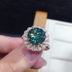 Macro detail of luxury green moissanite ring with double-layer diamond halo on rose gold band