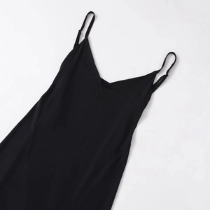 Sleeveless black crepe maxi dress with V-neckline and thin straps on white background