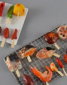 Realistische PVC-voedselspiesen met maïs en paprika op een metalen grill en keramisch bord