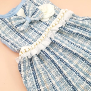 Detail of blue tweed pet dress with 3D white flowers, blue bows and pearl trimming