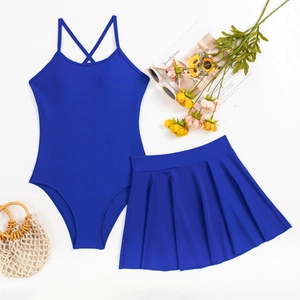 Flat lay of navy blue two-piece swimdress with criss-cross back straps and pleated skirt