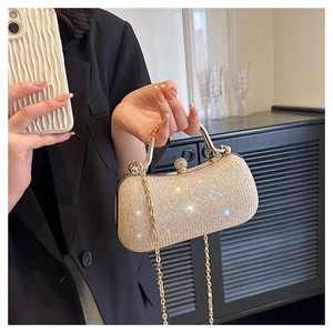 Close-up of champagne gold sequin evening bag with elegant metal handle and chain