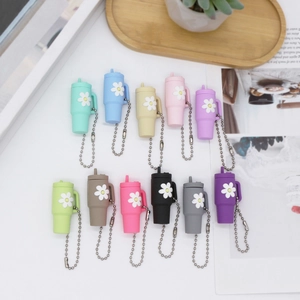Mini silicone tumbler keychains with daisy flower pattern in eleven vibrant colors