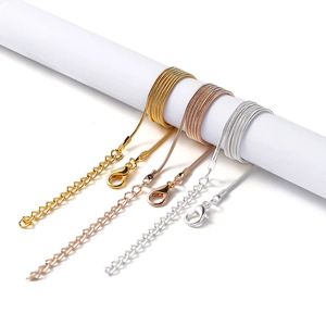 Detailed view of snake chains in gold, rose gold and silver with lobster clasps