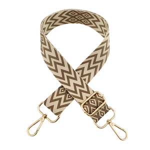 Detail of adjustable woven diamond pattern shoulder strap with gold metal hooks