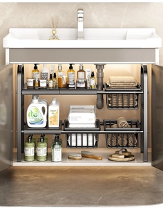 Detail view of adjustable black metal under-sink organizer with sliding baskets for storage
