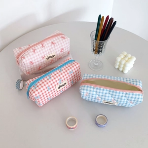Detailed internal and external views of quilted bow pencil cases in pink red and blue