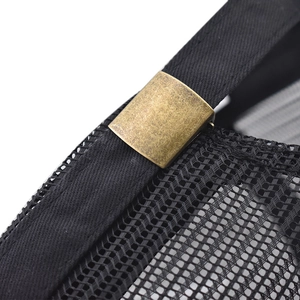 Close-up of vintage bronze adjustable buckle and mesh texture on a black cap
