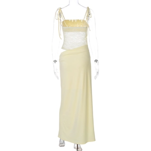 Detail of delicate lace patchwork and fine mesh texture on the lemon yellow slip dress