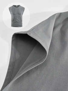 Close-up of grey knit vest showing detailed underarm stitching and fabric texture