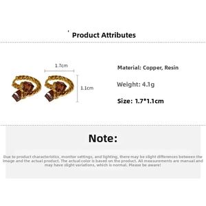 Detail view of twisted gold-plated hoop earrings with brown cubic zirconia dimensions