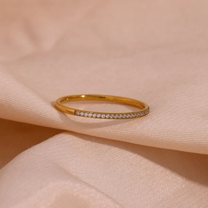 Detailed macro view of an 18K gold plated minimalist ring with micro-inlaid zircon