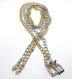 Detailed view of heavy hip hop metal chain belts in gold and silver with square buckles