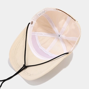 Inside view of beige quick-dry sun hat with adjustable cord and sweatband for outdoor use