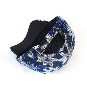 Women's blue lace flower baseball cap with adjustable metal buckle from a side back view