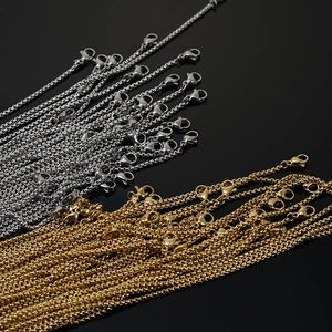 Detail of 18K gold and silver stainless steel square pearl chains with lobster clasps