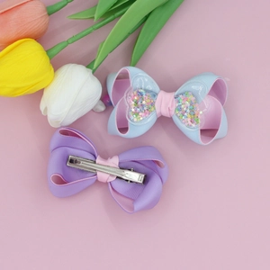 Glittering star sequins hair clips with pink tulips on aesthetic background