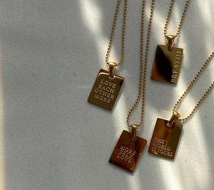 Gold rectangular pendant necklaces with motivational engravings on fine bead chains