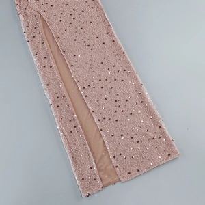 Detailed embroidery with silver sequins and white beads on a nude slit dress