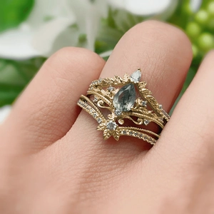 Bohemian gold ring set featuring a pear-cut gray stone and vintage leaf vine engravings