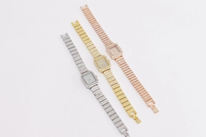 Detail of square quartz watches in silver gold and rose gold with full rhinestone metal bands