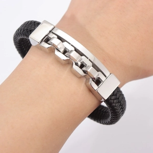 Close-up of black braided leather bracelet with silver geometric lock clasp on male wrist