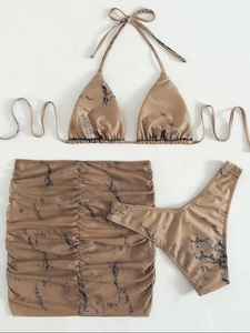 Flat lay of marble print 3-piece bikini set with a halter top and ruched mini skirt