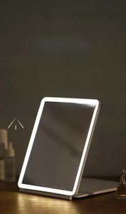 Detailed view of white LED travel makeup mirror with touch sensor and foldable thin base
