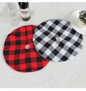 Detail view of buffalo plaid Christmas tree skirts in red, black and white checkered patterns