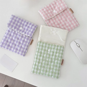 Quilted cotton storage pouches in lavender, pink, and mint green with button closure