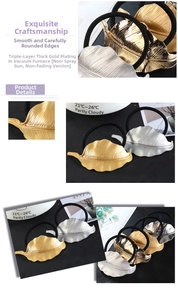Macro detail of leaf-shaped metal hair ties showing golden leaf vein texture and elastic bands