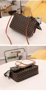 Detailed view of brown monogram handbag with silk scarf and magnetic snap closure