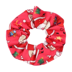 Detail of red Christmas scrunchie with festive Santa, tree, and gift box patterns