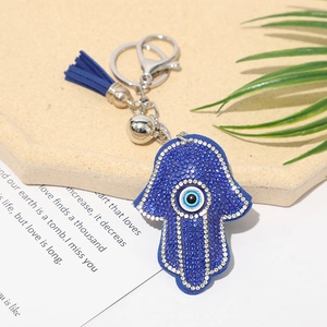 Close-up of Evil Eye Hamsa Hand keychain with blue crystal rhinestones and tassel detail