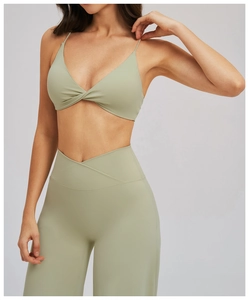 Détail du soutien-gorge de sport torsadé et du legging de yoga taille haute en vert sauge