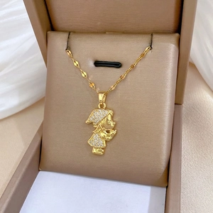 Golden cartoon girl pendant necklace with white zircons on a soft white satin background